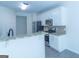 Modern kitchen with stainless steel appliances, granite counters, and ample cabinet space at 8030 Snapwell Dr, Fairburn, GA 30213