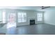 Living Room with fireplace, breakfast bar, light gray floors, and an exit to the backyard at 8030 Snapwell Dr, Fairburn, GA 30213