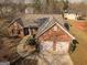 Aerial view of brick home with two car garage and manicured front lawn at 1109 Norsworthy Ml, Hampton, GA 30228