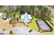 Aerial view of the community clubhouse, swimming pool, tennis court and parking in a wooded setting at 1109 Norsworthy Ml, Hampton, GA 30228