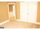 Bedroom with carpet and double doors to closet and a view to another room at 1109 Norsworthy Ml, Hampton, GA 30228