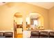 Living room featuring a passthrough to the kitchen with white cabinets and granite countertops at 1109 Norsworthy Ml, Hampton, GA 30228
