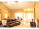 Comfortable living room with leather seating and an open layout flowing into the dining area at 1109 Norsworthy Ml, Hampton, GA 30228