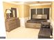 Main bedroom with a large dresser and bed with great trim on the walls at 1109 Norsworthy Ml, Hampton, GA 30228