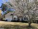 Charming two-story home with brick facade and blossoming tree in the front yard at 645 Legend Sw Ct, Atlanta, GA 30331
