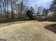 Expansive backyard space featuring a wooden fence and shed, perfect for gardening or recreational activities at 125 Mcintosh Estates Dr, Sharpsburg, GA 30277