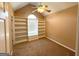 Neutral-toned bedroom with carpet, a ceiling fan, built-in shelving, and a window seat at 125 Mcintosh Estates Dr, Sharpsburg, GA 30277