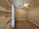 Bright bedroom featuring a ceiling fan, neutral walls, carpet, and built-in shelving at 125 Mcintosh Estates Dr, Sharpsburg, GA 30277