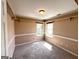 Cozy bedroom featuring neutral walls, carpet floors, and sun-filled windows, offering a warm, inviting space at 125 Mcintosh Estates Dr, Sharpsburg, GA 30277