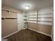 Bedroom featuring carpeted floors, built-in shelves, and closet, creating a practical and organized space at 125 Mcintosh Estates Dr, Sharpsburg, GA 30277