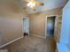 Bedroom featuring carpet, a ceiling fan, built-in shelving, and access to a closet at 125 Mcintosh Estates Dr, Sharpsburg, GA 30277