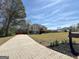 Beautiful residence with a long driveway, showcasing ample yard space and mature trees at 125 Mcintosh Estates Dr, Sharpsburg, GA 30277