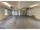 Spacious garage with ample room for parking and storage, including two doors and a window at 125 Mcintosh Estates Dr, Sharpsburg, GA 30277