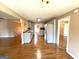 Open concept kitchen with stainless steel appliances, a breakfast bar, and hardwood floors throughout at 125 Mcintosh Estates Dr, Sharpsburg, GA 30277