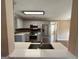 Updated kitchen boasts stainless steel appliances and modern countertops at 125 Mcintosh Estates Dr, Sharpsburg, GA 30277