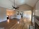 Open concept living room features hardwood floors and flows into the kitchen at 125 Mcintosh Estates Dr, Sharpsburg, GA 30277