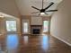 Bright living room features hardwood floors, a ceiling fan and decorative fireplace with direct access to the deck at 125 Mcintosh Estates Dr, Sharpsburg, GA 30277