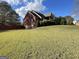 Expansive backyard with a lush lawn, enclosed by a charming red fence at 239 Overland Trl, Mcdonough, GA 30252