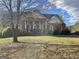 Traditional brick home with a covered porch, set in a serene landscape with mature trees at 239 Overland Trl, Mcdonough, GA 30252