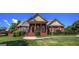 Charming brick home featuring a covered front porch, well-maintained lawn, and mature landscaping at 239 Overland Trl, Mcdonough, GA 30252