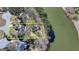 Aerial view showcases stunning lakefront property surrounded by trees and lush greenery at 4852 Jacobs Cove Pt, Buford, GA 30519