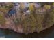 Aerial view of a large home surrounded by mature trees and a pond at 4852 Jacobs Cove Pt, Buford, GA 30519