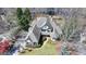 Elegant home with lush landscaping, mature trees, and inviting curb appeal, aerial view at 4852 Jacobs Cove Pt, Buford, GA 30519