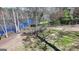Picturesque backyard with vibrant trees, a rustic fence, and a serene lake backdrop at 4852 Jacobs Cove Pt, Buford, GA 30519