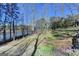 Expansive backyard with mature trees and views of the lake, offering privacy and natural beauty at 4852 Jacobs Cove Pt, Buford, GA 30519