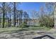 Lush backyard with a well-maintained lawn and views of the tranquil lake beyond the trees at 4852 Jacobs Cove Pt, Buford, GA 30519