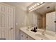 Bathroom featuring a double sink vanity, a large mirror, and neutral-toned walls at 4852 Jacobs Cove Pt, Buford, GA 30519