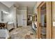 Spacious bathroom with stone floors, dual vanities, a walk-in shower, and plenty of natural light at 4852 Jacobs Cove Pt, Buford, GA 30519