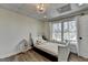 Bright bedroom featuring a large window and a cozy bed with decorative pillows at 4852 Jacobs Cove Pt, Buford, GA 30519