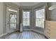 Bright bedroom featuring a door to a deck, large windows, and modern decor at 4852 Jacobs Cove Pt, Buford, GA 30519