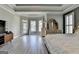 Spacious bedroom with outdoor access, a bay window, and an elegant dresser at 4852 Jacobs Cove Pt, Buford, GA 30519