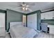 Comfortable bedroom featuring light gray walls, and a window with view of wooded backyard at 4852 Jacobs Cove Pt, Buford, GA 30519