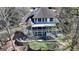 Aerial view of elegant home with a putting green, spacious patios, and lush surroundings at 4852 Jacobs Cove Pt, Buford, GA 30519