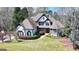 Aerial view of a stunning two-story home with a well-manicured lawn and mature trees at 4852 Jacobs Cove Pt, Buford, GA 30519