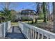 Stunning lakefront home featuring a spacious deck, dock access, and manicured landscaping at 4852 Jacobs Cove Pt, Buford, GA 30519