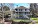 Beautiful home showcasing an elevated deck, putting green, and meticulously maintained landscaping at 4852 Jacobs Cove Pt, Buford, GA 30519