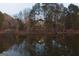 Exterior of a lake home with lights on in the evening hours at 4852 Jacobs Cove Pt, Buford, GA 30519