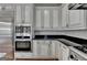 Kitchen with stainless steel appliances and custom white cabinetry at 4852 Jacobs Cove Pt, Buford, GA 30519