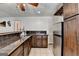 Basement kitchen area with dark wood cabinetry, tile countertops, and stainless steel refrigerator at 4852 Jacobs Cove Pt, Buford, GA 30519
