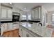 Beautiful kitchen with white cabinets, stainless steel appliances, and a large island at 4852 Jacobs Cove Pt, Buford, GA 30519