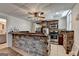 Basement kitchen features dark wood cabinets, stainless steel appliances, and stone accents at 4852 Jacobs Cove Pt, Buford, GA 30519