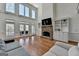 Bright and airy living room featuring a stone fireplace and built-in shelving at 4852 Jacobs Cove Pt, Buford, GA 30519