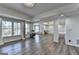 Bright living room with large windows offering natural light and stylish luxury vinyl plank flooring at 4852 Jacobs Cove Pt, Buford, GA 30519