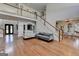 Open-concept living room with hardwood floors, staircase, and view of the dining room at 4852 Jacobs Cove Pt, Buford, GA 30519