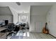 Bright office space with a window view, desk, chair, and a guitar leaning against the wall at 4852 Jacobs Cove Pt, Buford, GA 30519