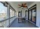 Spacious porch with dining furniture and a ceiling fan, perfect for outdoor relaxation at 4852 Jacobs Cove Pt, Buford, GA 30519